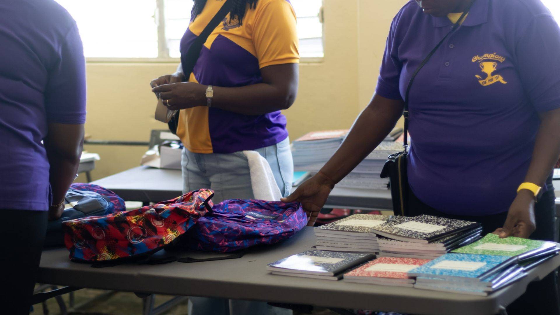 Happy Grove community members with school supplies